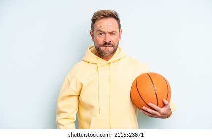 Middle Age Handsome Man Looking Puzzled And Confused. Basketball Concept