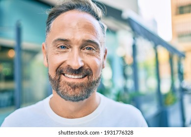 Middle Age Handsome Man Smiling Happy Looking To The Camera At The City.