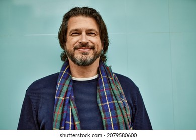 Middle Age Handsome Man Smiling Leaning On The Wall