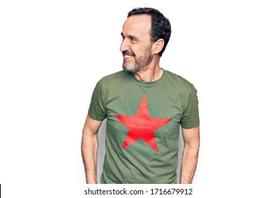 Middle Age Handsome Man Wearing T-shirt With Revolutionary Red Star Over White Background Looking To Side, Relax Profile Pose With Natural Face And Confident Smile.