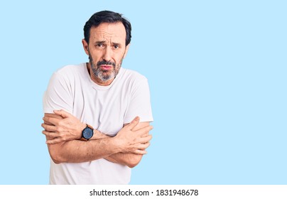 Middle Age Handsome Man Wearing Casual T-shirt Shaking And Freezing For Winter Cold With Sad And Shock Expression On Face 