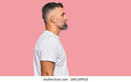 Middle Age Handsome Man Wearing Casual White Tshirt Looking To Side, Relax Profile Pose With Natural Face And Confident Smile. 