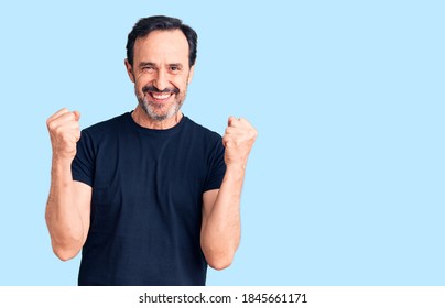Middle age handsome man wearing casual t-shirt celebrating surprised and amazed for success with arms raised and open eyes. winner concept.  - Shutterstock ID 1845661171