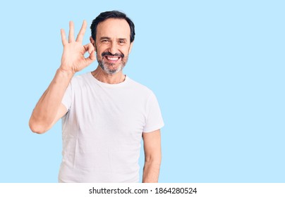 Middle age handsome man wearing casual t-shirt smiling positive doing ok sign with hand and fingers. successful expression.  - Shutterstock ID 1864280524