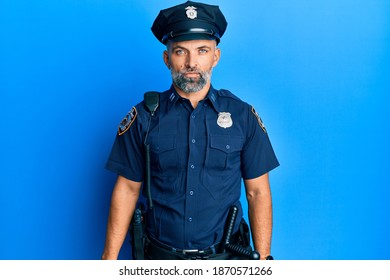 Middle Age Handsome Man Wearing Police Uniform Relaxed With Serious Expression On Face. Simple And Natural Looking At The Camera. 