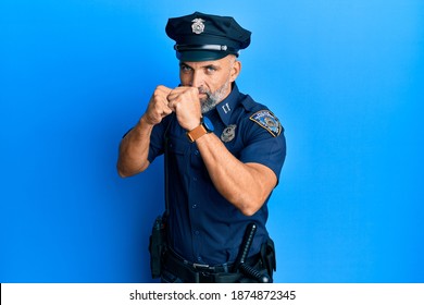 Middle Age Handsome Man Wearing Police Uniform Ready To Fight With Fist Defense Gesture, Angry And Upset Face, Afraid Of Problem 