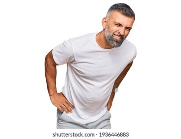 Middle Age Handsome Man Wearing Casual White Tshirt Suffering Of Backache, Touching Back With Hand, Muscular Pain 