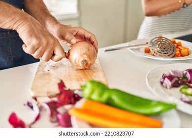 Middle Age Hispanic Couple Cooking At Kitchen