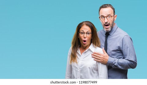 Middle Age Hispanic Couple In Love Wearing Glasses Over Isolated Background Afraid And Shocked With Surprise Expression, Fear And Excited Face.