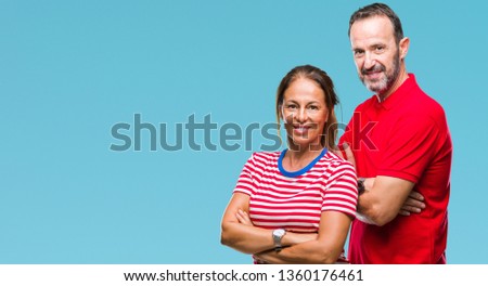 Middle age hispanic couple in love over isolated background happy face smiling with crossed arms looking at the camera. Positive person.
