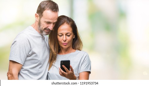 Middle Age Hispanic Couple Texting Message On Smartphone Ver Isolated Background With A Confident Expression On Smart Face Thinking Serious