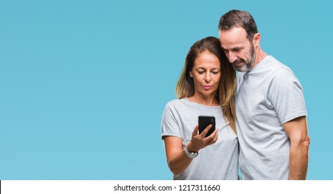 Middle Age Hispanic Couple Texting Message On Smartphone Ver Isolated Background With A Confident Expression On Smart Face Thinking Serious