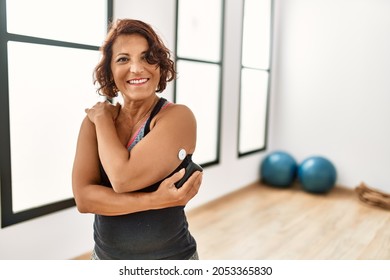 Middle age hispanic diabetic woman control glucose after training at sport center. - Powered by Shutterstock