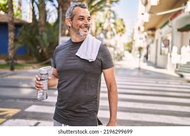 Middle age hispanic man smiling confident wearing sportswear at street - Powered by Shutterstock