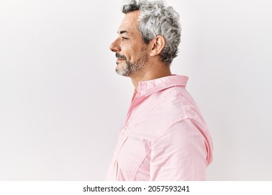 Middle Age Hispanic Man Standing Over Isolated Background Looking To Side, Relax Profile Pose With Natural Face With Confident Smile. 
