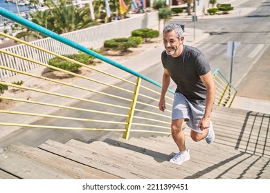 Middle age hispanic man wearing sportswear running at street - Powered by Shutterstock