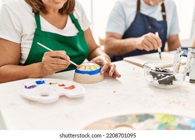 Middle Age Hispanic Painter Couple Painting At Art Studio.