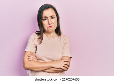 Middle Age Hispanic Woman With Arms Crossed Gesture Depressed And Worry For Distress, Crying Angry And Afraid. Sad Expression. 