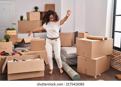 Middle Age Hispanic Woman Dancing At New Home