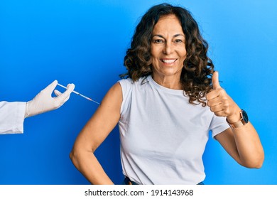 Middle Age Hispanic Woman Getting Vaccine Smiling Happy And Positive, Thumb Up Doing Excellent And Approval Sign 