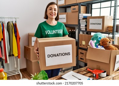 Middle age hispanic woman holding donations box at donations stand - Shutterstock ID 2170207705