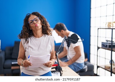 Middle Age Hispanic Woman Singing At Music Studio Looking At The Camera Blowing A Kiss Being Lovely And Sexy. Love Expression. 