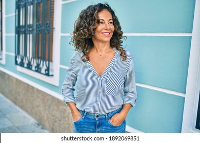 Middle Age Hispanic Woman Smiling Happy Walking At The City.