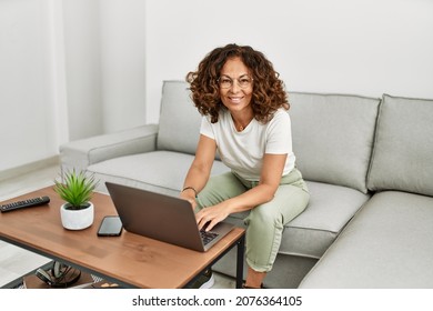 Middle Age Hispanic Woman Smiling Confident Using Laptop At Home