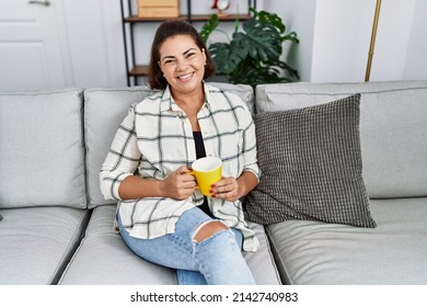 Middle Age Hispanic Woman Smiling Confident Drinking Coffee At Home