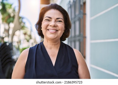 Middle age hispanic woman smiling happy and confident outdoors on a sunny day - Powered by Shutterstock