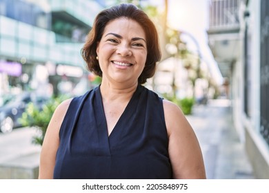 Middle age hispanic woman smiling happy and confident outdoors on a sunny day - Powered by Shutterstock