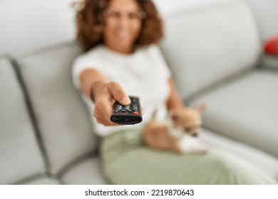 Middle Age Hispanic Woman Smiling Confident Watching Tv At Home