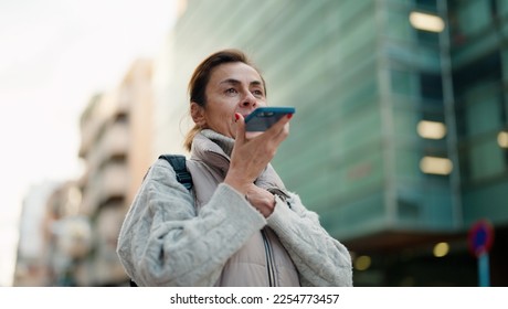 Middle age hispanic woman smiling confident talking on the smartphone at street - Shutterstock ID 2254773457