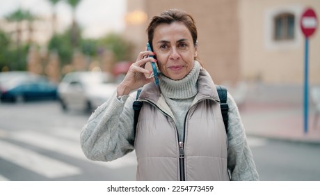 Middle age hispanic woman smiling confident talking on the smartphone at street - Shutterstock ID 2254773459
