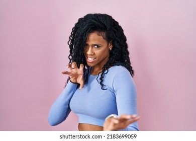 Middle Age Hispanic Woman Standing Over Pink Background Smiling Funny Doing Claw Gesture As Cat, Aggressive And Sexy Expression 