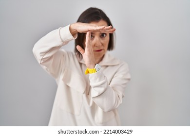 Middle Age Hispanic Woman Standing Over Isolated Background Doing Time Out Gesture With Hands, Frustrated And Serious Face 