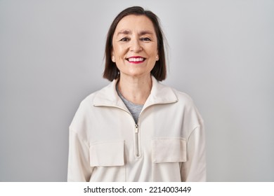 Middle Age Hispanic Woman Standing Over Isolated Background With A Happy And Cool Smile On Face. Lucky Person. 