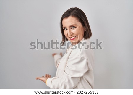 Similar – Young female sitting by table and making clay or ceramic mug in her working studio