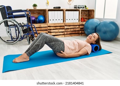 Middle Age Hispanic Woman Training Abdominal Muscles At Physiotherapy Clinic