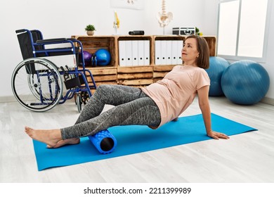 Middle Age Hispanic Woman Training Abdominal Muscles At Physiotherapy Clinic