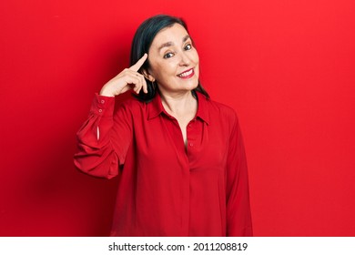 Middle Age Hispanic Woman Wearing Casual Clothes Smiling Pointing To Head With One Finger, Great Idea Or Thought, Good Memory 