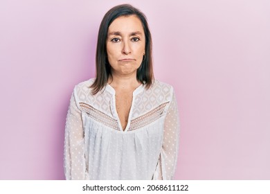 Middle Age Hispanic Woman Wearing Casual Clothes Depressed And Worry For Distress, Crying Angry And Afraid. Sad Expression. 