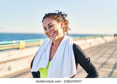 Middle Age Hispanic Woman Working Out With Towel For The Sweat At Promenade