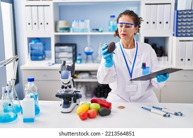 Middle Age Hispanic Woman Working At Laboratory