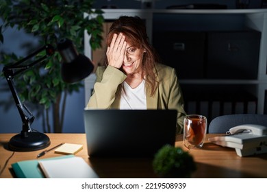 Middle Age Hispanic Woman Working Using Computer Laptop At Night Covering One Eye With Hand, Confident Smile On Face And Surprise Emotion. 