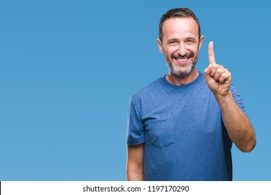 Middle age hoary senior man over isolated background showing and pointing up with finger number one while smiling confident and happy.