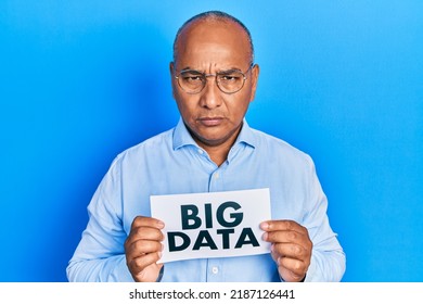 Middle Age Latin Man Holding Paper With Big Data Message Depressed And Worry For Distress, Crying Angry And Afraid. Sad Expression. 
