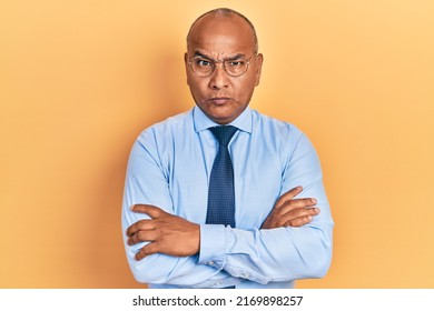 Middle age latin man wearing business clothes with arms crossed gesture skeptic and nervous, frowning upset because of problem. negative person.  - Shutterstock ID 2169898257