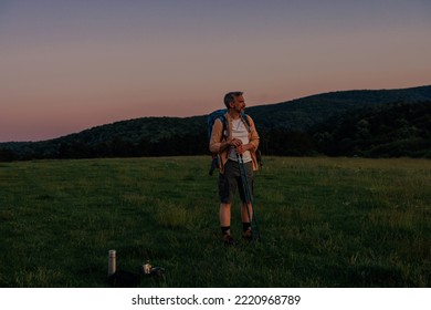 Middle Age Male Hiker Walking With Backpack In Nature