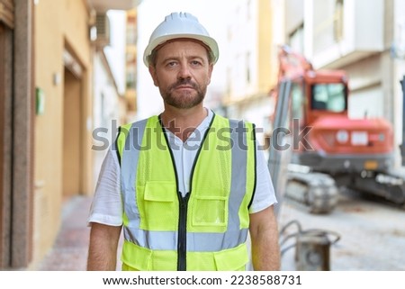 Middle age man architect standing with relaxed expression at street